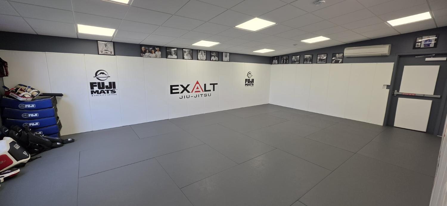 Exalt mat room with the name on the wall pads